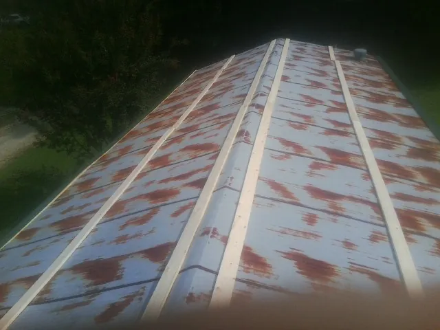 Rusted metal roof panels with new wood purlins before replacement — Storm Damage Roof Repair in Freedom by Roofing Brothers