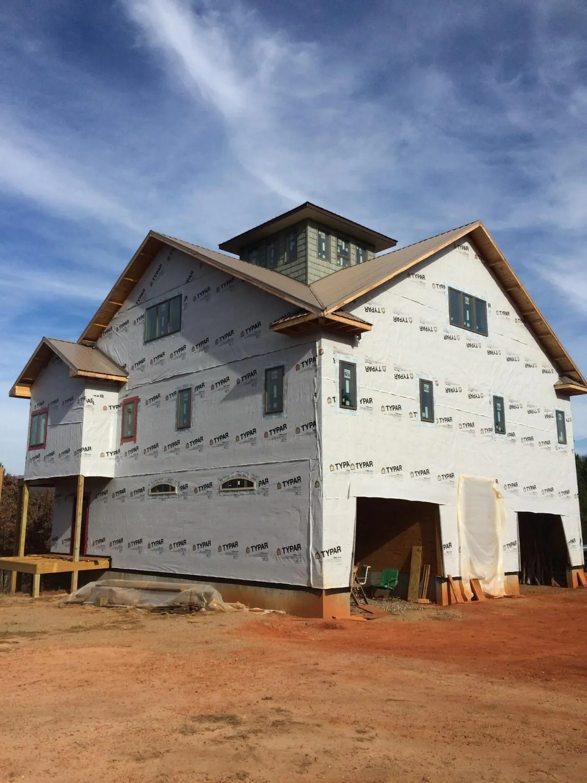 New two story house under construction with a cupola and gabled roofs in Freedom
